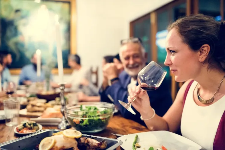 A woman at dinner in a restaurant with business colleagues
