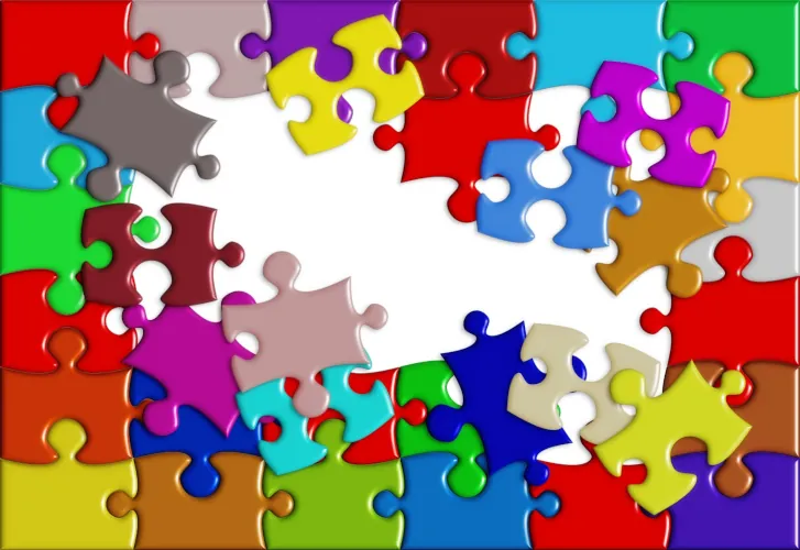 Bright and colorful puzzle pieces, some assembled and some still waiting to be placed
