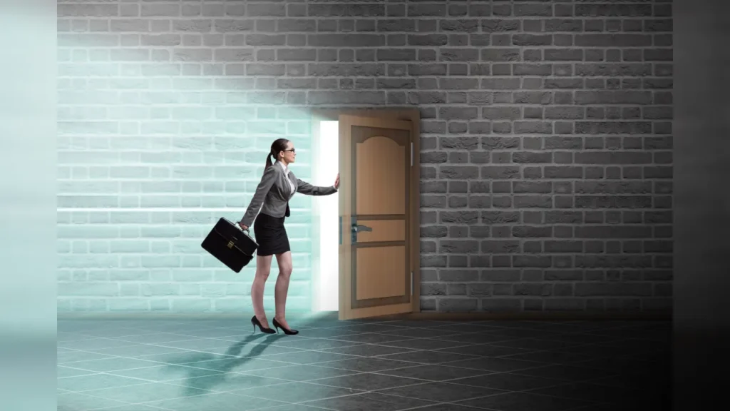Businesswoman walking out an open door