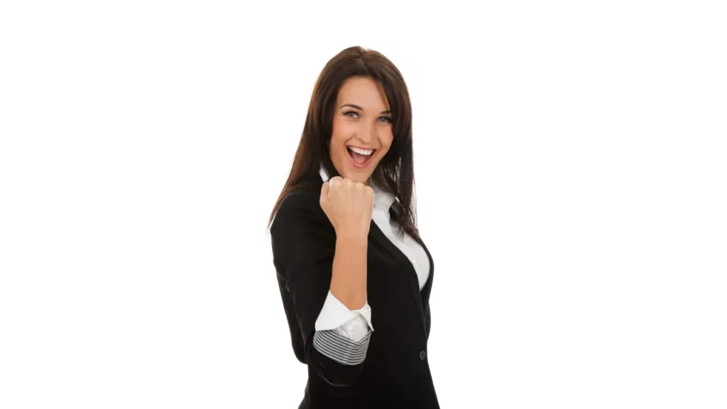 Portrait of happy young businesswoman celebrating success with bent arm and fist