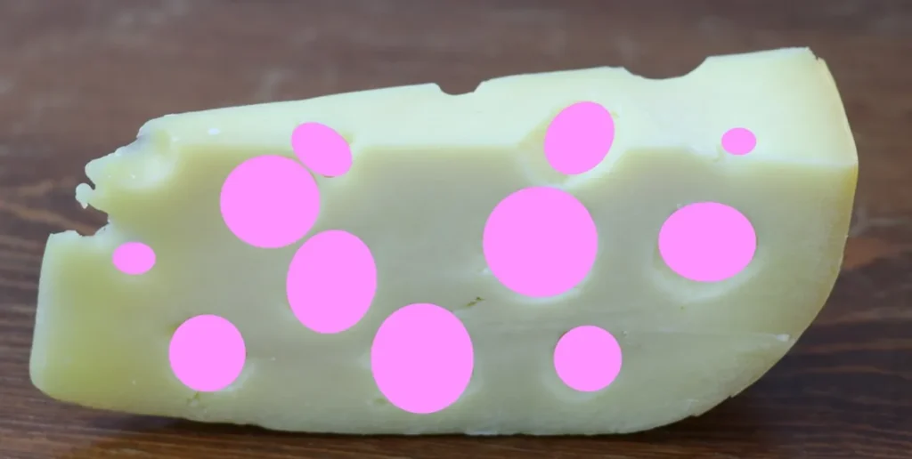A wedge of Swiss cheese with all the holes filled in with pink circles
