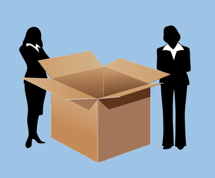 Two businesswomen standing outside an open box