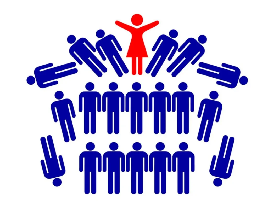 Red figure of woman standing at top of organization hierarchy with two rows of blue male figures beneath her. To the side are several male figures tumbling down that the woman pushed aside
