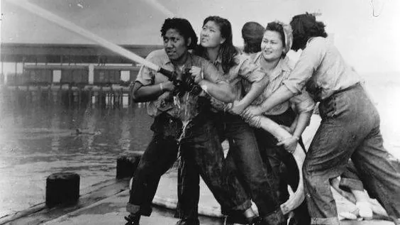women using firehose to put our fire after pearl Harbor attack